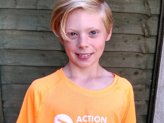 A boy wearing a Radiotherapy UK t-shirt