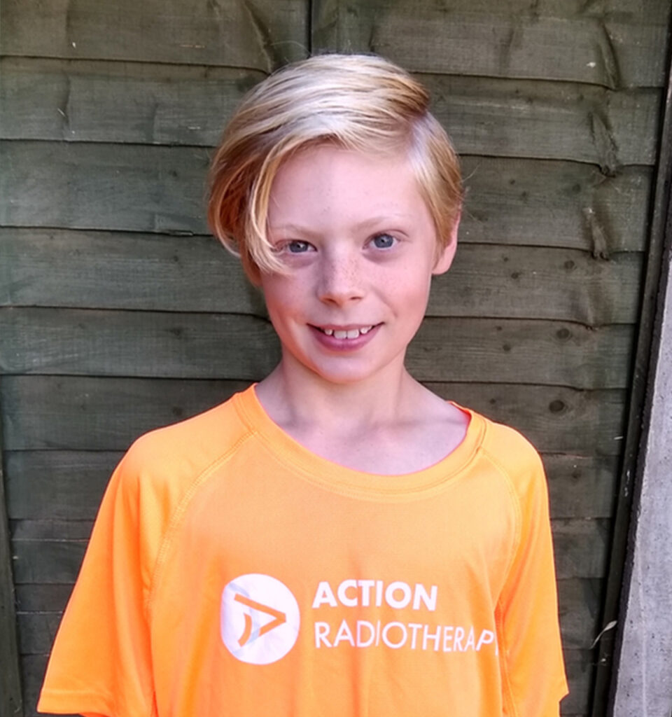 A boy wearing a Radiotherapy UK t-shirt