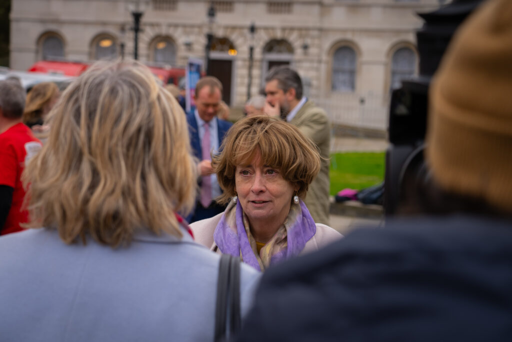 Professor Pat Price campaigning outside Westminster on behalf of patients waiting too long for cancer treatment